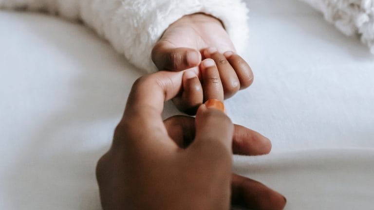 mom and baby holding hands