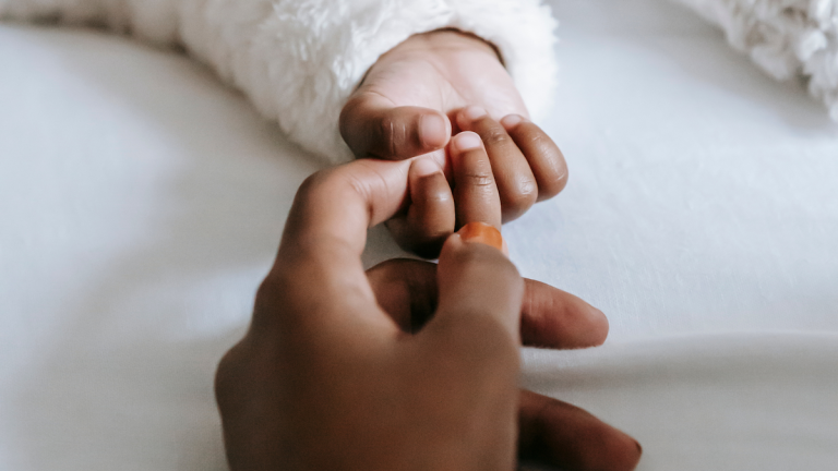 mom and baby holding hands